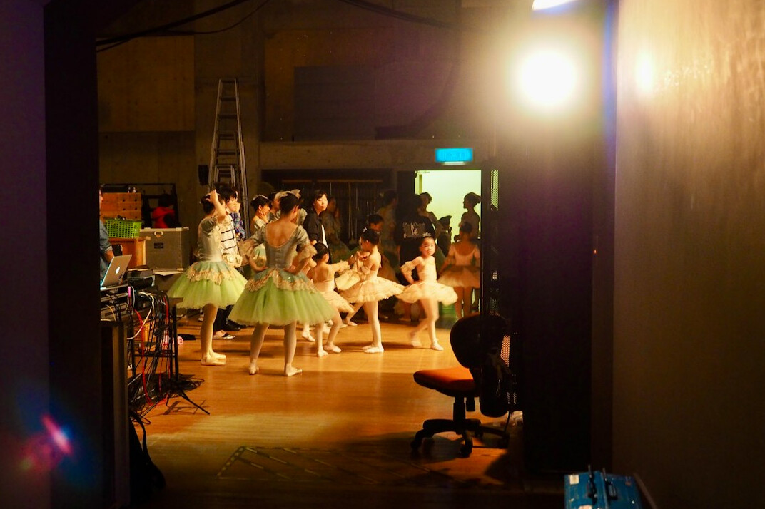 Production crew gathered around a camera on a television studio floor